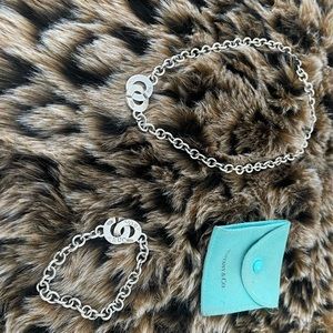 Authentic Tiffany and Company interlocking C’s necklace and bracket set.